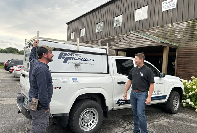 HVAC Mechanical & BAS Service 1 Image of Two People Standing Next to a CTI Truck